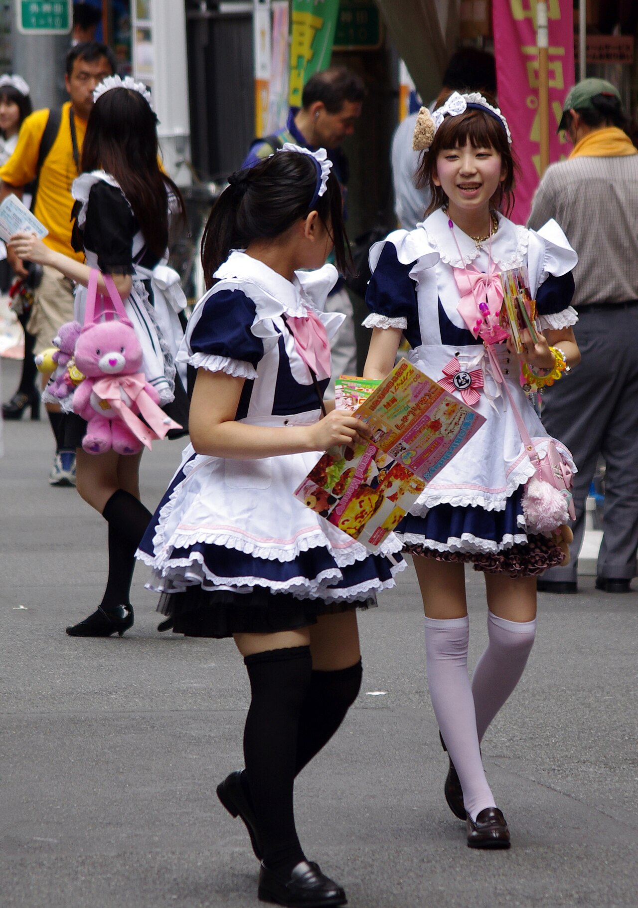 Maid cafe staff distributing flyers on Akihabara street