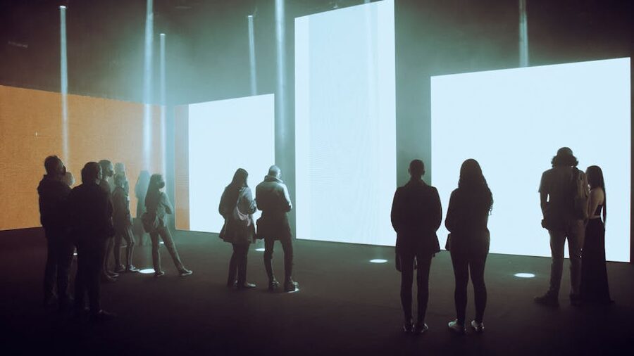 Visitors exploring an immersive digital-art exhibition with large illuminated screens
