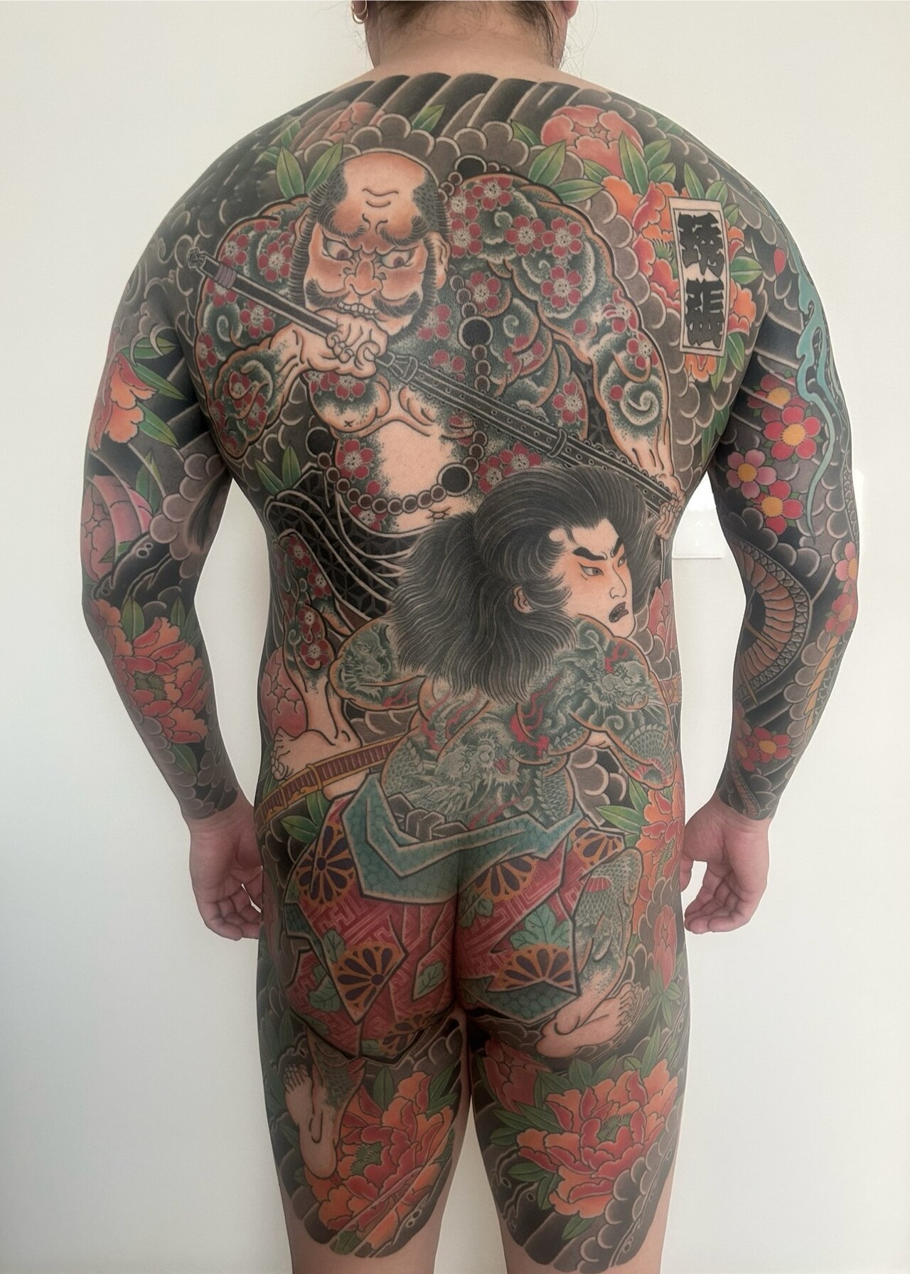 Traditional Japanese irezumi full-back tattoo with koi and floral design