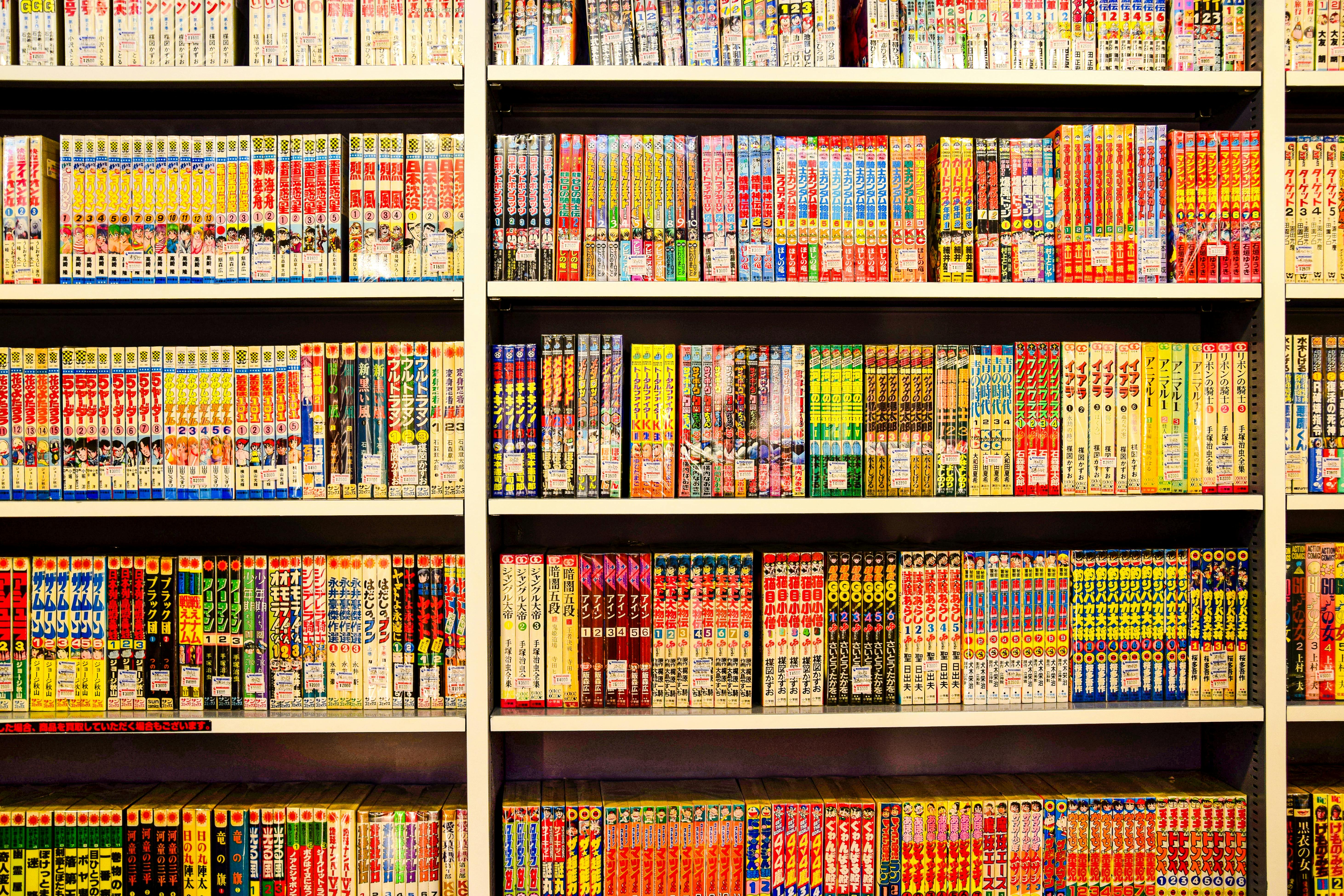 Shelves of Japanese manga with distinctive spine design in a bookstore