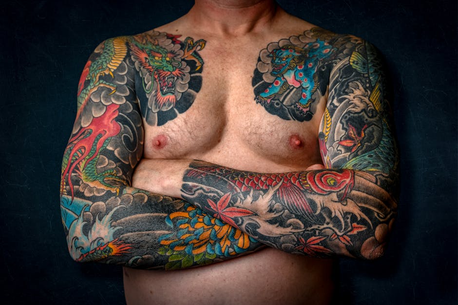 Shirtless man with colourful Japanese sleeve tattoos