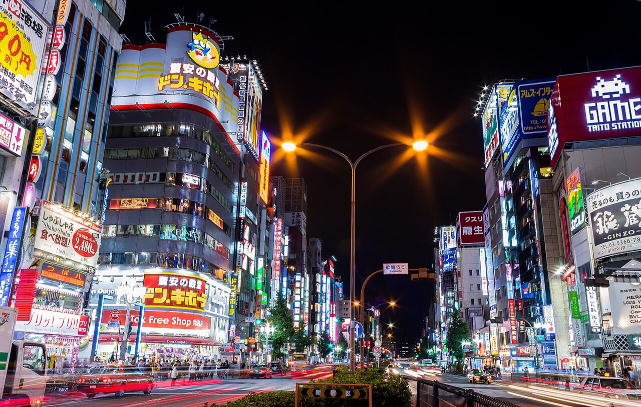 Kabukicho streetscape at night showing dense nightlife signage