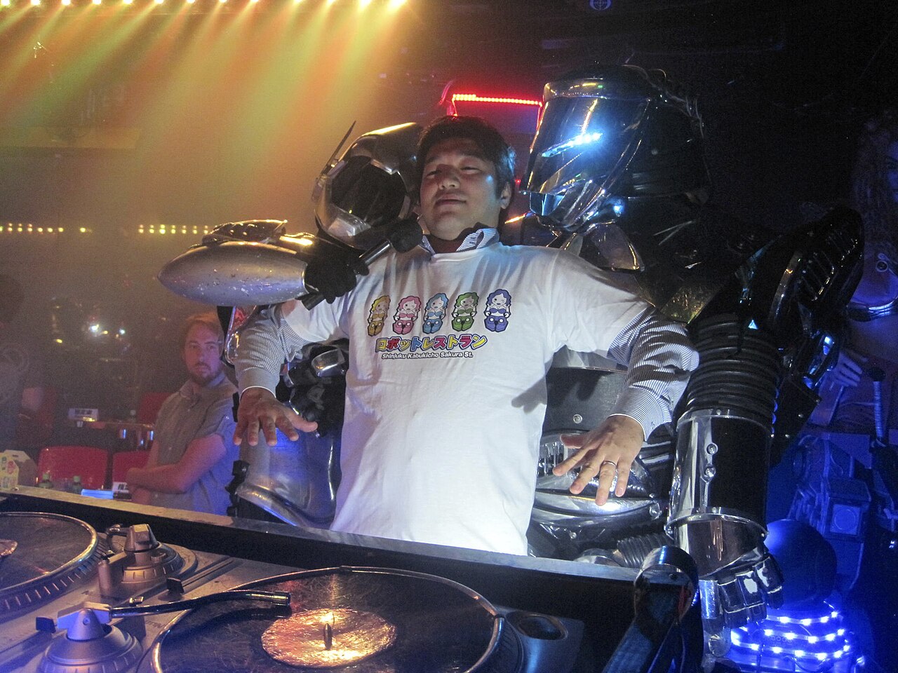 Performers pose as captured by robot figures during a Robot Restaurant show in Shinjuku, Tokyo