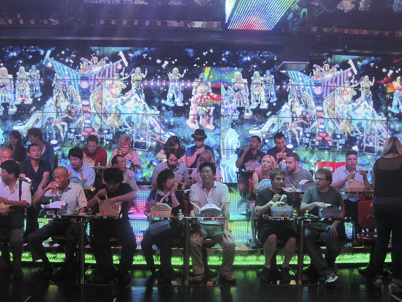 Female performers ride military-themed robots during the Robot Restaurant show in Shinjuku, Tokyo