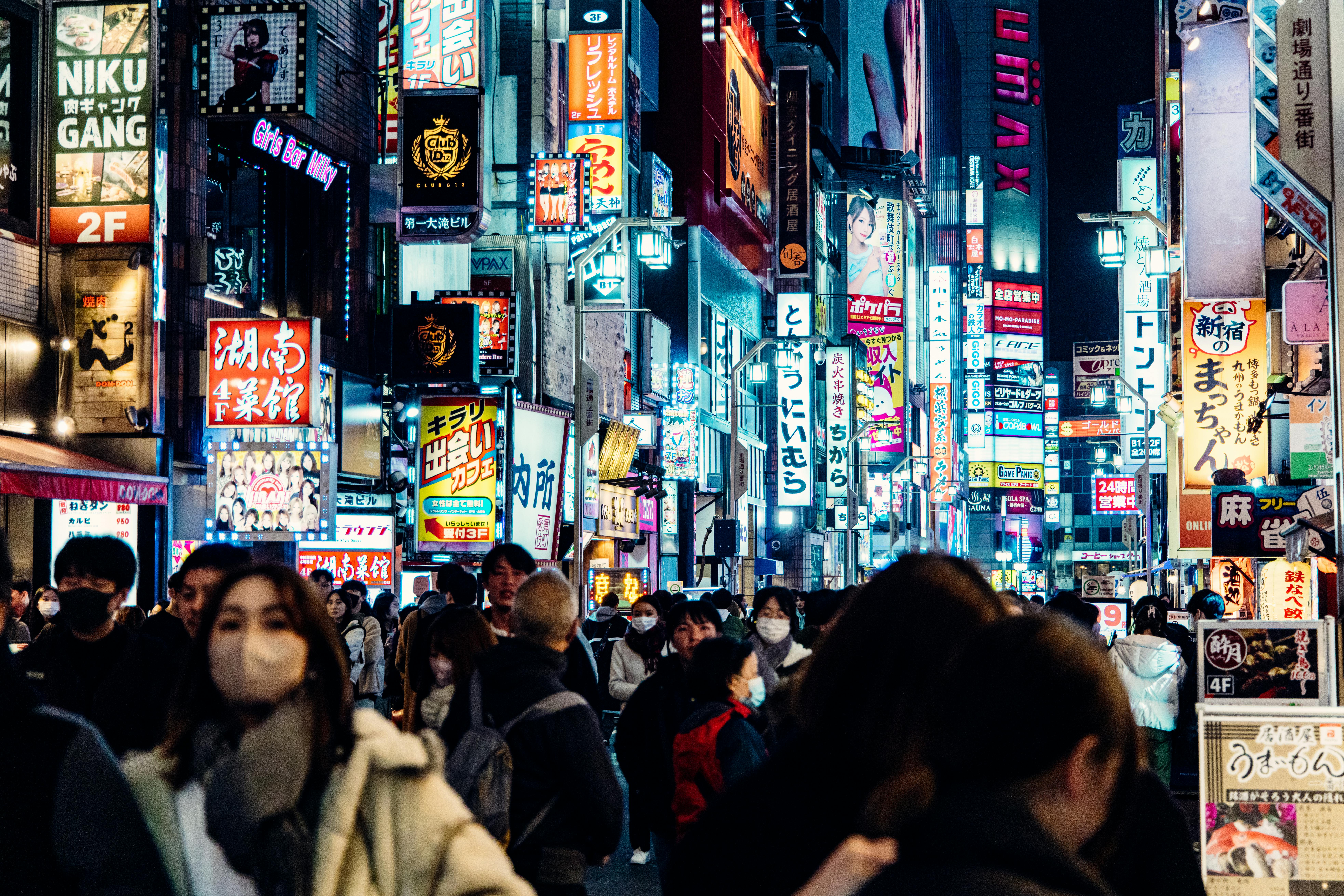 Crowds on the neon-lit streets of Shinjuku, Tokyo at night