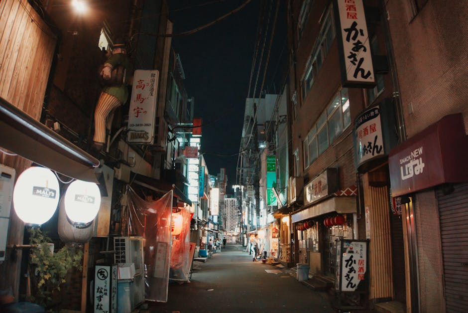 A narrow Tokyo nightlife alley with small bars and glowing signs