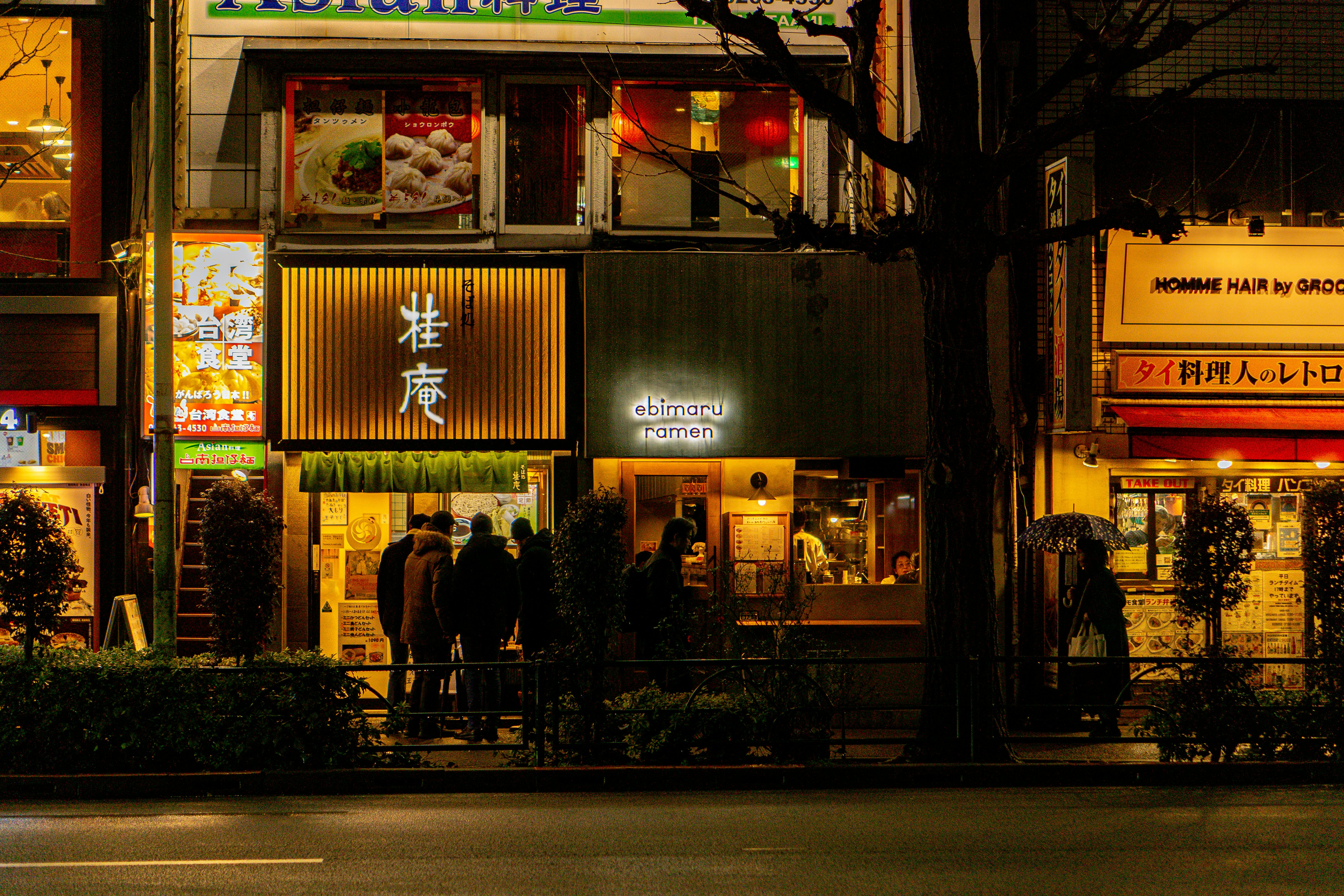 Late-night Tokyo street with illuminated ramen shop signage