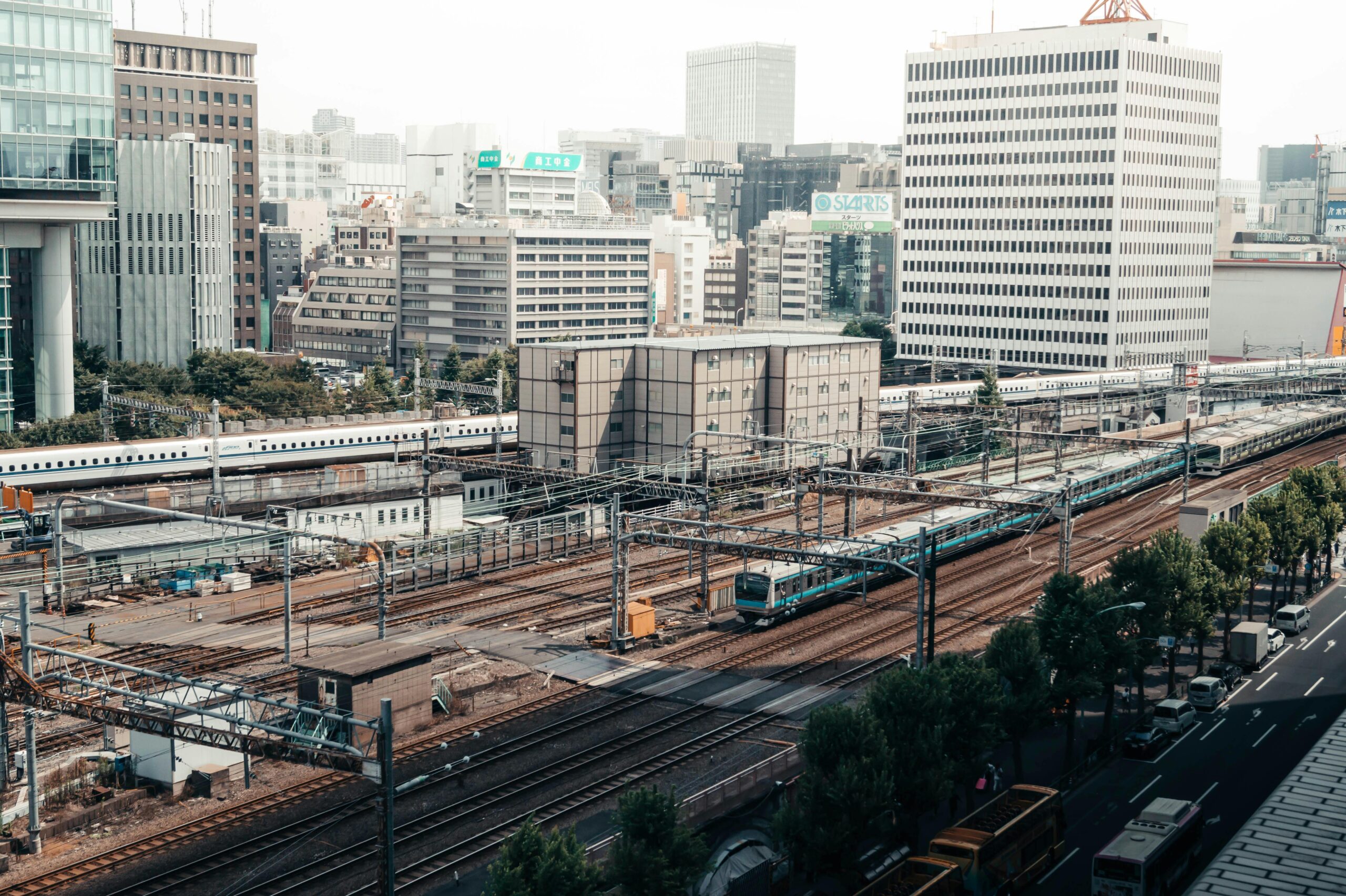 Tokyo train station with city skyscrapers