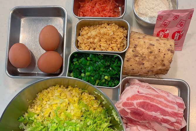 Small-Group Osaka-Style Okonomiyaki Cooking Class - Stir-fried pork and kimchi while the pancake cooks